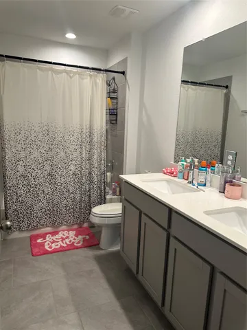 a bedroom with a bed and chandelier