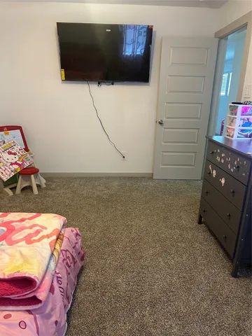 a bedroom with a bed and a couch