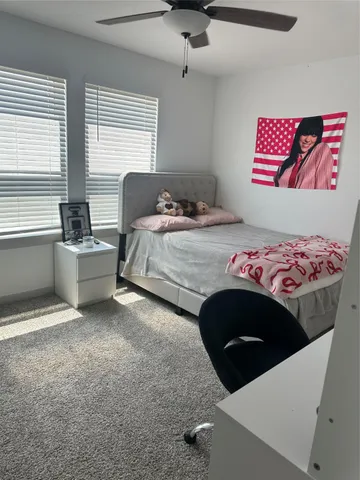 a bedroom with a bed and a chair