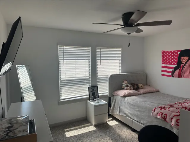 a bedroom with a workspace