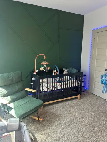 a bedroom with furniture and a baby crib
