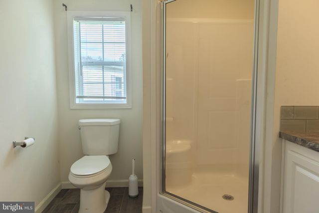 a white toilet sitting next to a bathroom sink