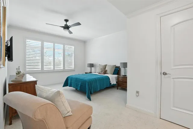 a bedroom with two beds and windows