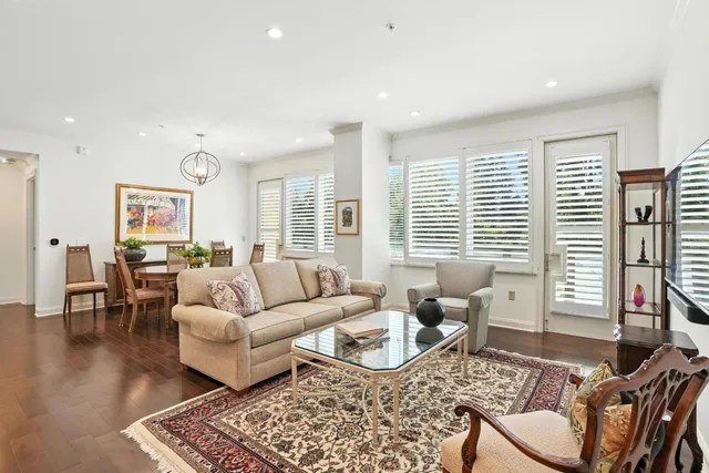 a living room with furniture and floor to ceiling windows