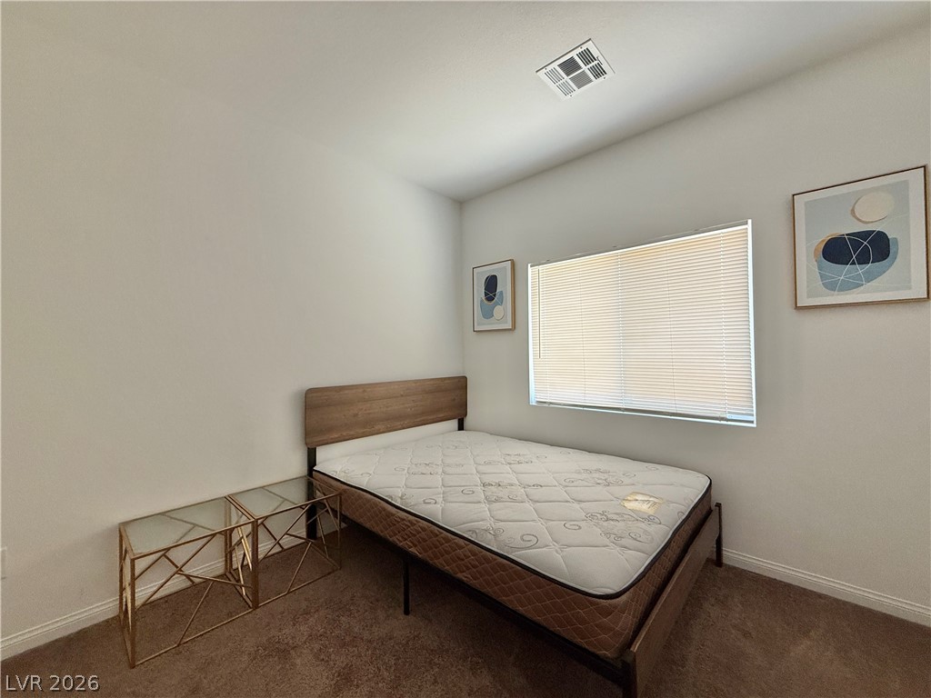 7777 South Westwind Road Las Vegas, NV 89139 - Photo 19 of 46 Cozy and well-lit, this bedroom offers a comfortable retreat with ample natural light.