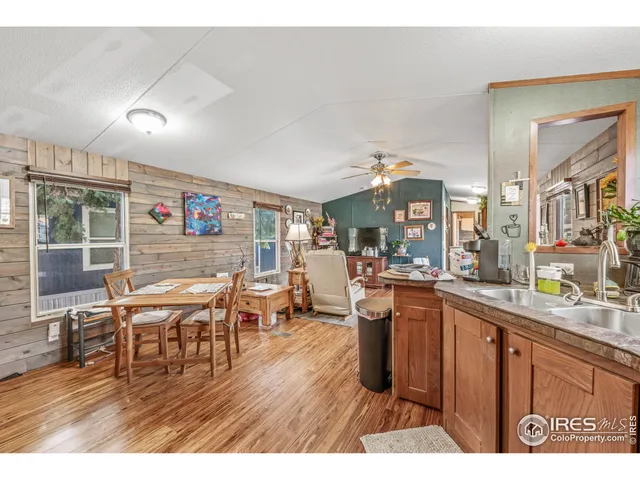 a open kitchen with stainless steel appliances granite countertop a dining table chairs and granite counter tops