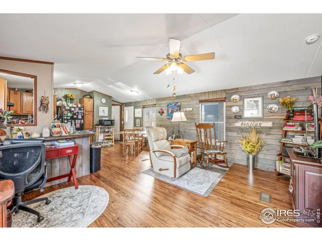 a living room with lots of furniture and view of kitchen