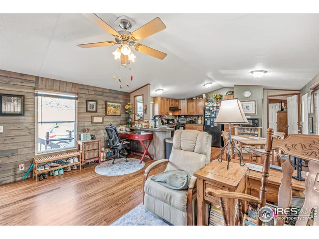 a living room with furniture kitchen view and a chandelier