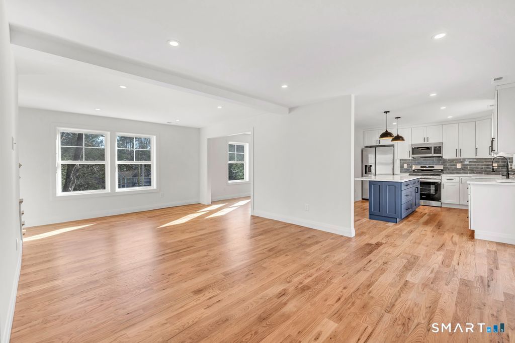 100 Tashua Road Trumbull, CT 06611 - Photo 8 of 29 a view of empty room with wooden floor and kitchen