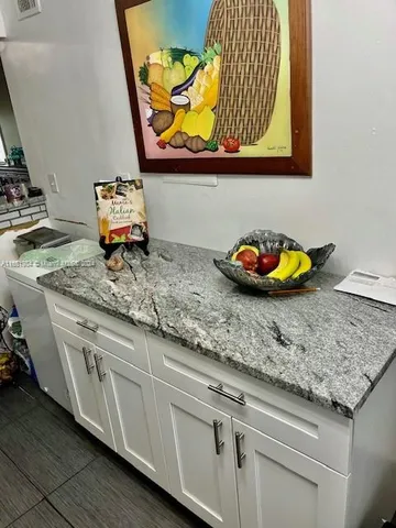 a sink with kitchen countertops and a stove