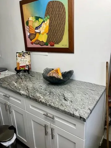 a kitchen with kitchen island a stove a sink and wooden floor