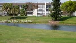6100 Northwest 44th Street, Unit 405 Lauderhill, FL 33319 - Photo 2 of 46 a view of a lake with a building in the background