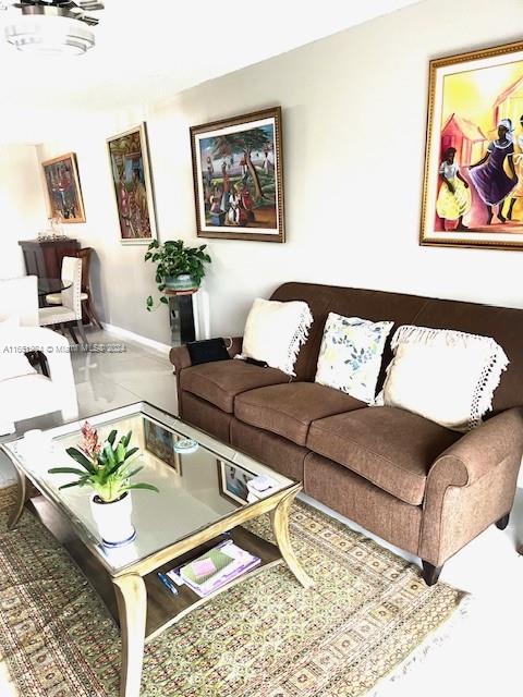 6100 Northwest 44th Street, Unit 405 Lauderhill, FL 33319 - Photo 22 of 46 a living room with furniture and painting on the wall