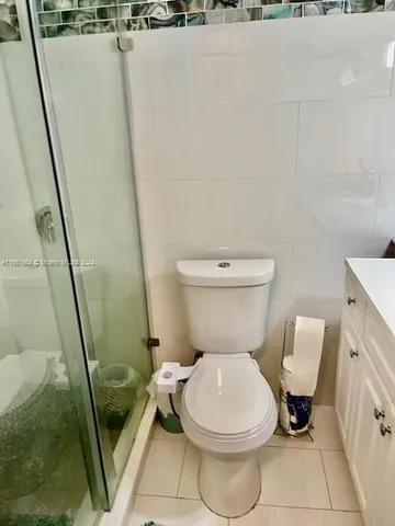 a white toilet sitting next to a sink