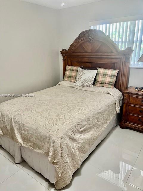 6100 Northwest 44th Street, Unit 405 Lauderhill, FL 33319 - Photo 35 of 46 a bed sitting in a bedroom next to a window