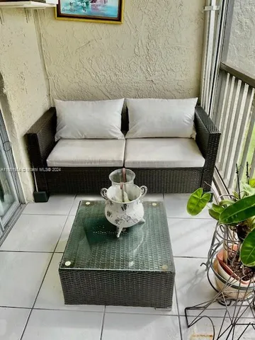 a living room with furniture and a mirror