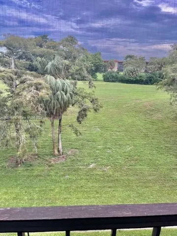 a view of a field with an ocean view