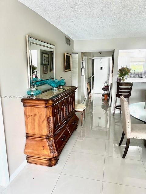 6100 Northwest 44th Street, Unit 405 Lauderhill, FL 33319 - Photo 8 of 46 a living room with furniture a flat screen tv and a table