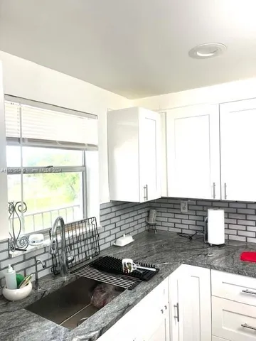 a kitchen with a sink and a large window