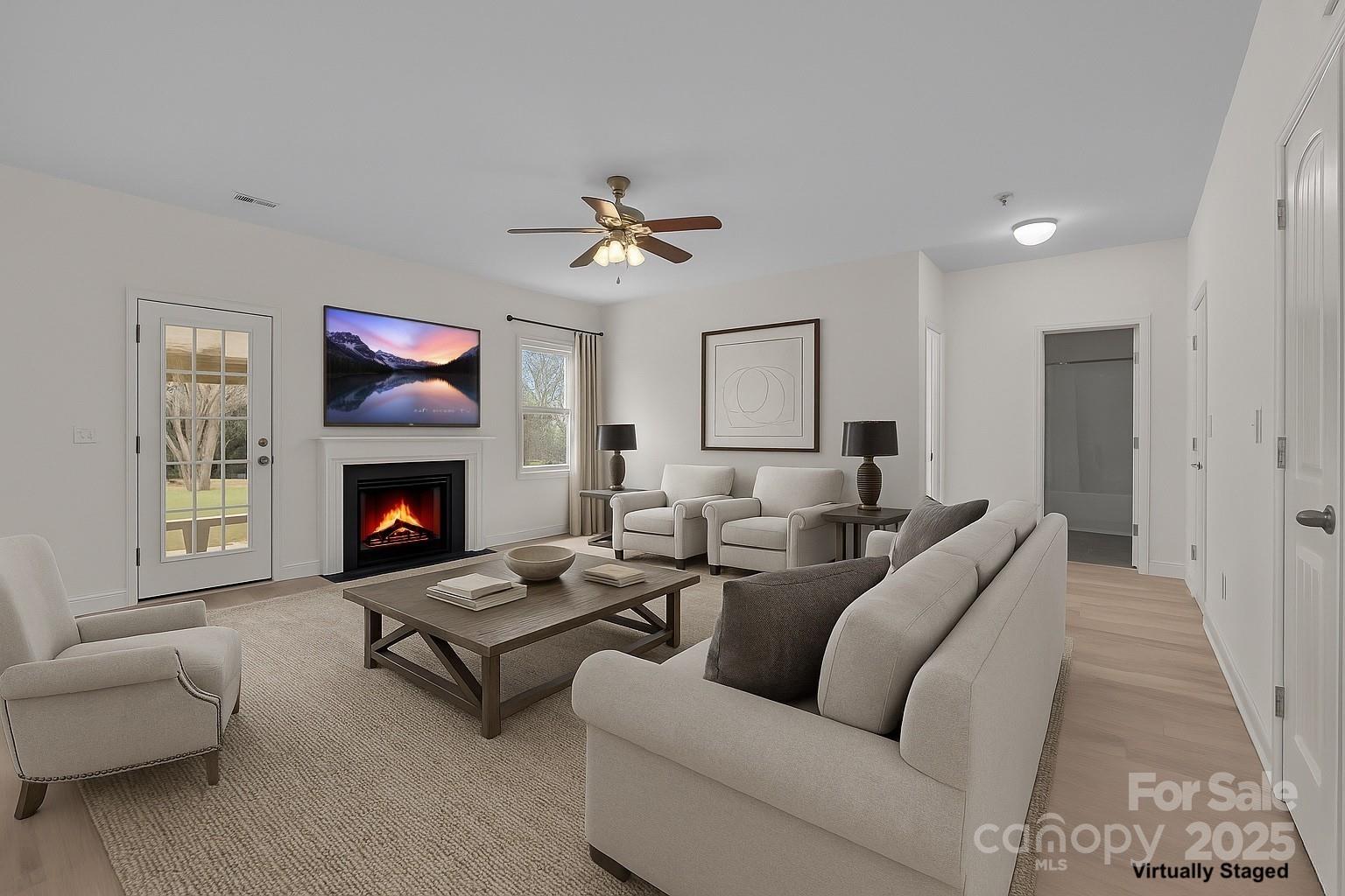 7020 Sedgewick Road Indian Trail, NC 28079 - Photo 13 of 42 a living room with furniture a flat screen tv and a fireplace
