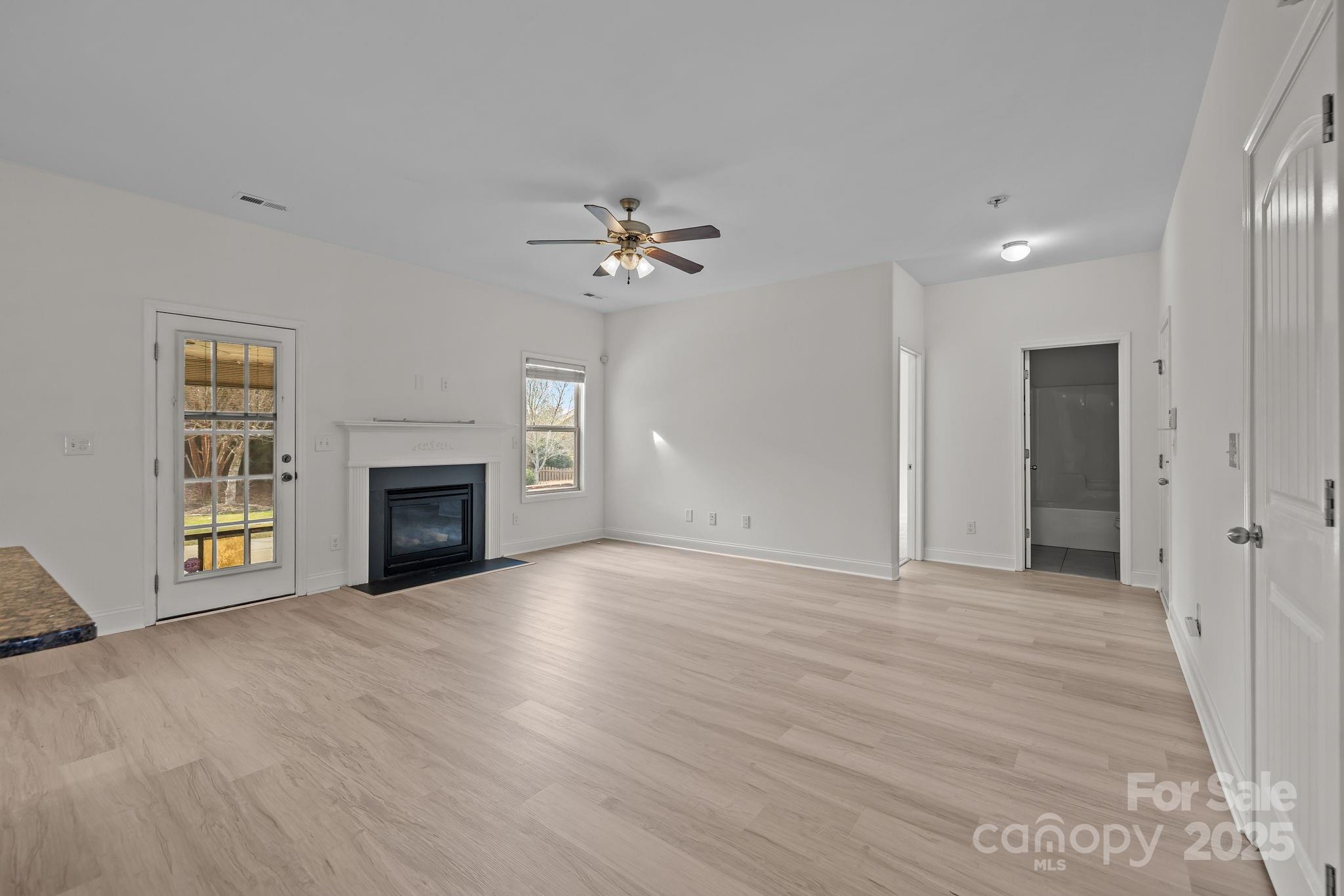 7020 Sedgewick Road Indian Trail, NC 28079 - Photo 14 of 42 a view of an empty room with a fireplace and a window