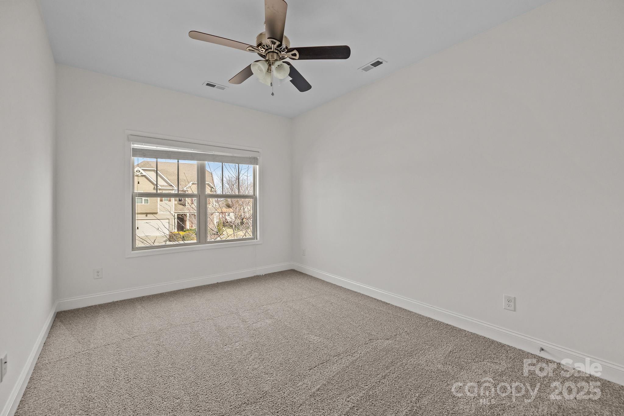 7020 Sedgewick Road Indian Trail, NC 28079 - Photo 26 of 42 an empty room with a window and a fan