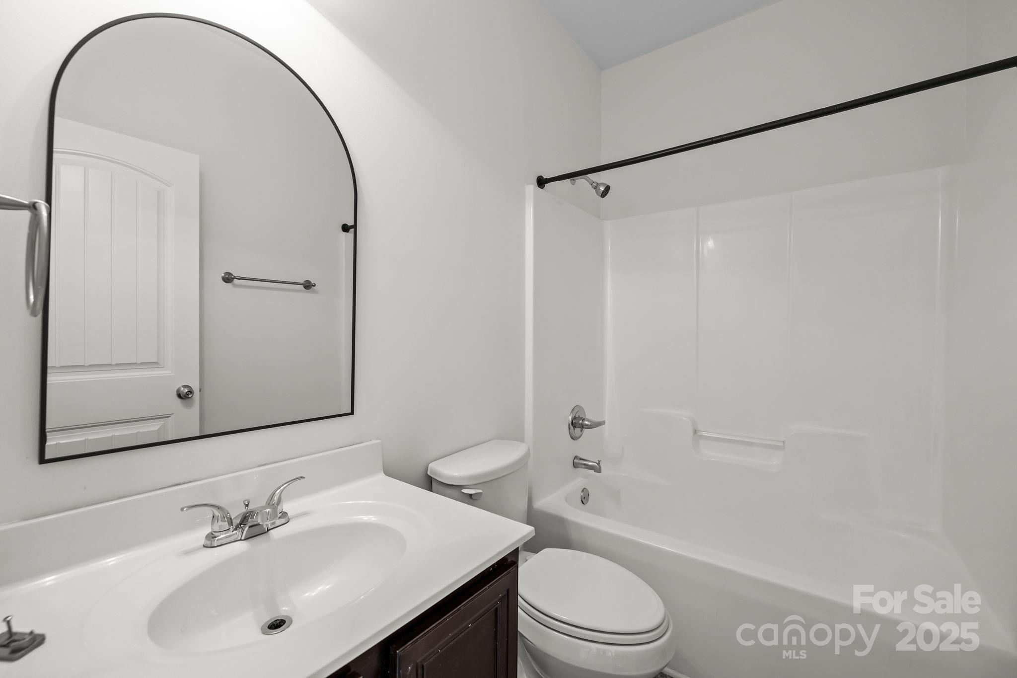 7020 Sedgewick Road Indian Trail, NC 28079 - Photo 27 of 42 a bathroom with a sink a toilet and a mirror