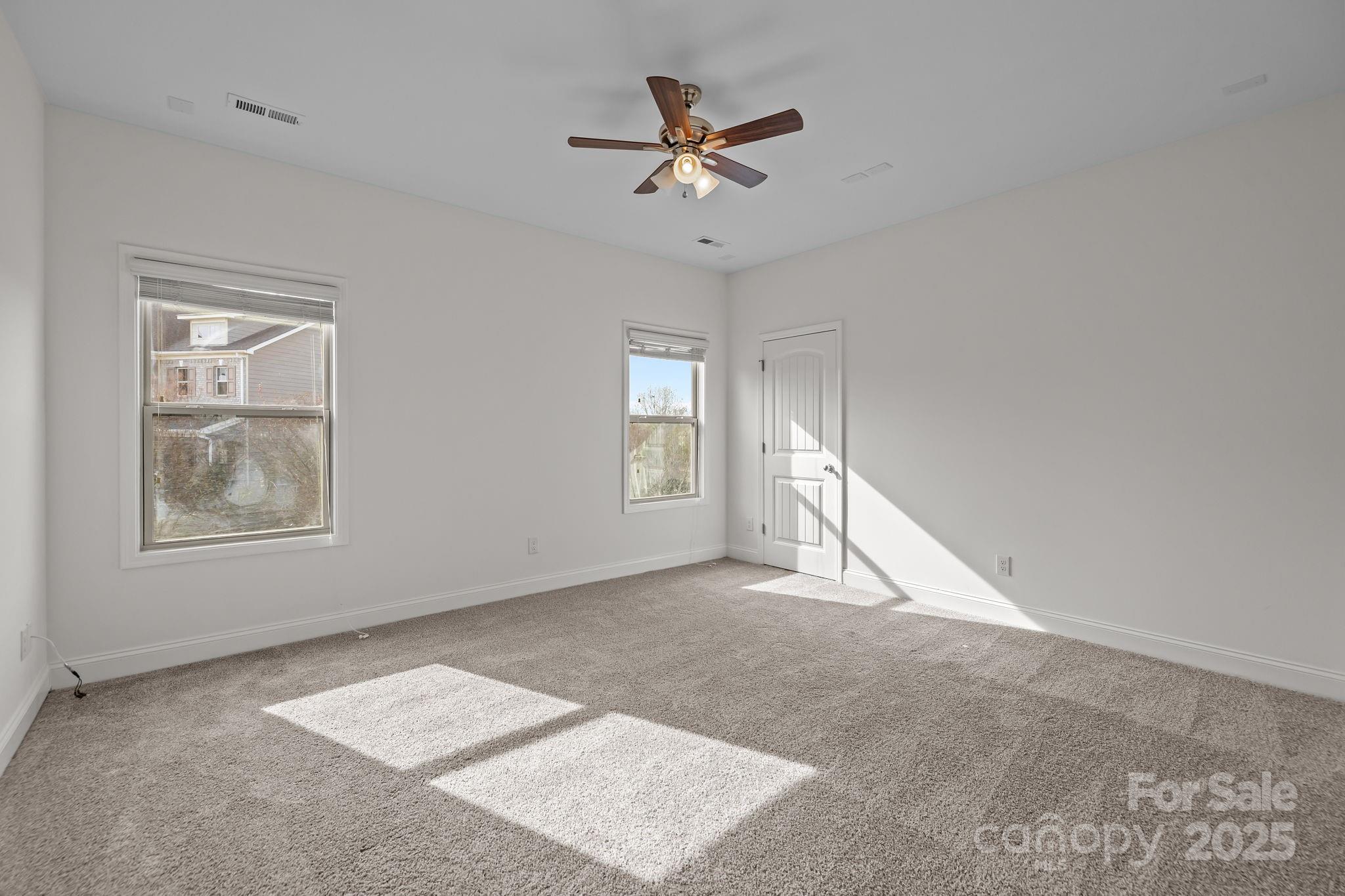 7020 Sedgewick Road Indian Trail, NC 28079 - Photo 31 of 42 an empty room with windows and fan
