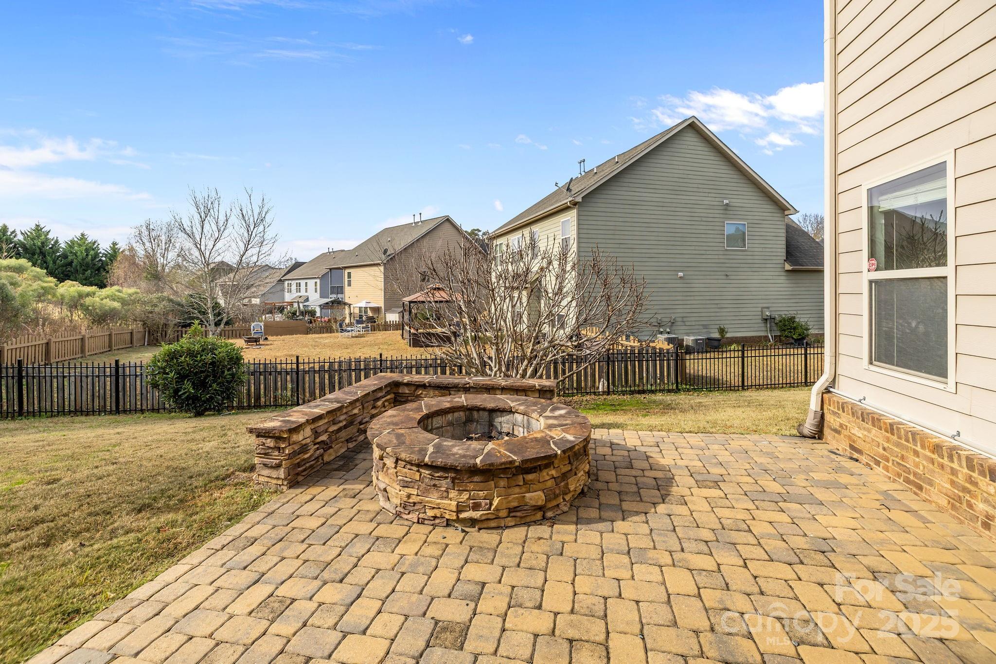 7020 Sedgewick Road Indian Trail, NC 28079 - Photo 35 of 42 a backyard of a house with barbeque oven fire pit and outdoor seating