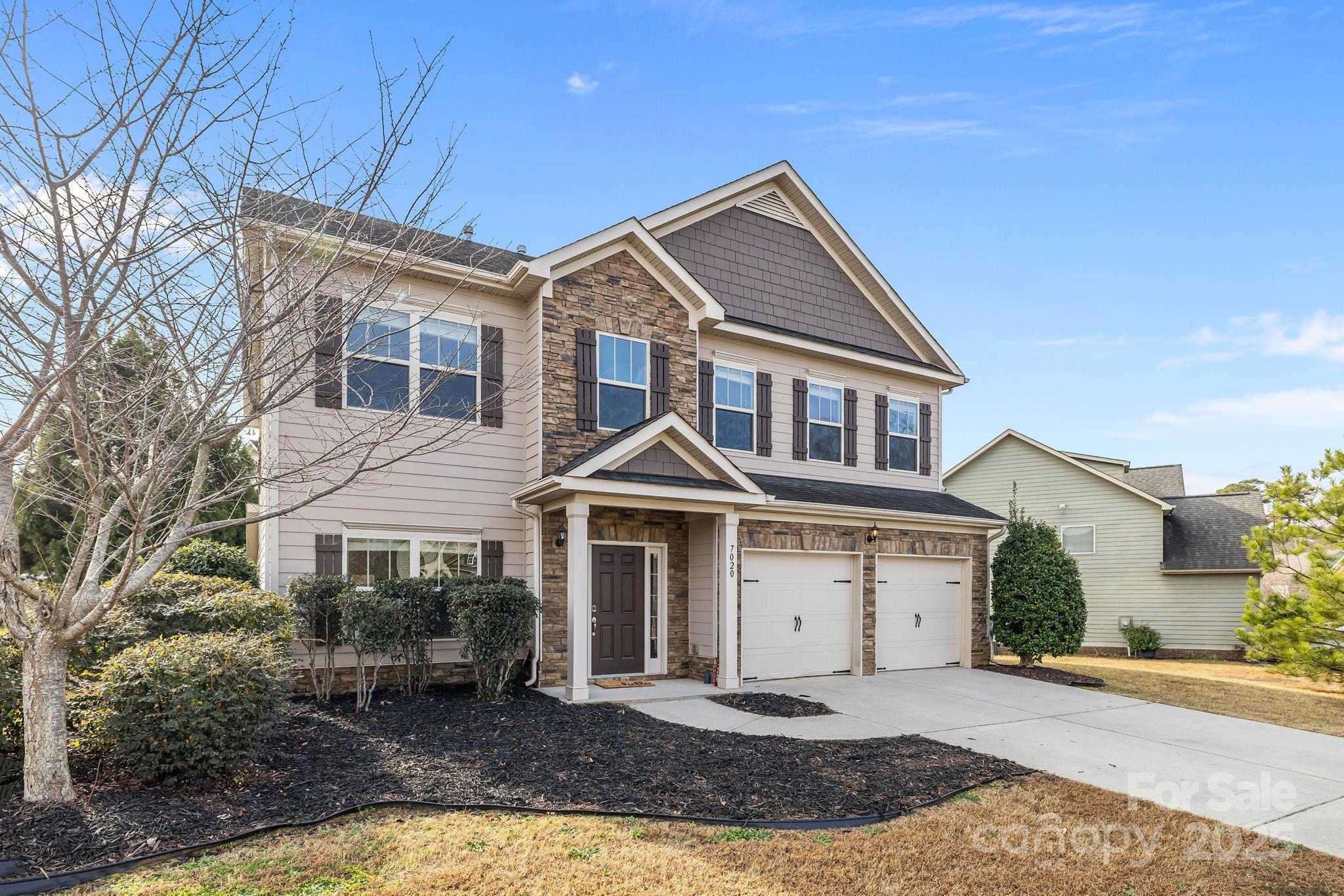 7020 Sedgewick Road Indian Trail, NC 28079 - Photo 41 of 42 a front view of a house with a yard and garage