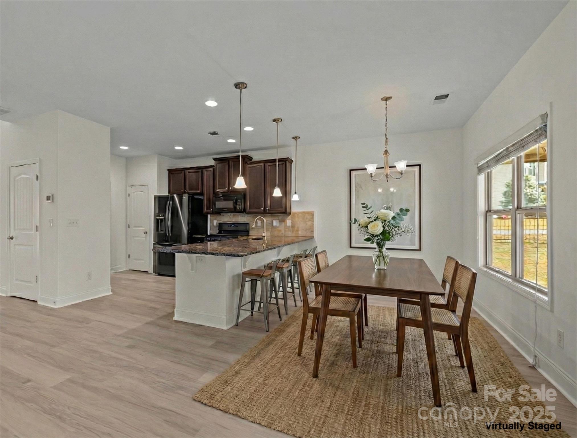 7020 Sedgewick Road Indian Trail, NC 28079 - Photo 9 of 42 a view of a dining room with furniture window and wooden floor