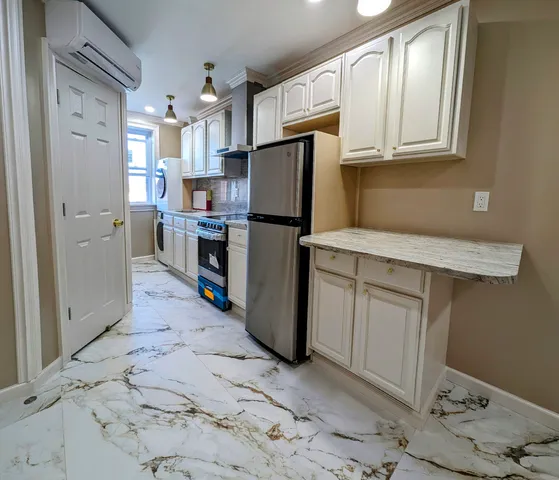 a kitchen with a refrigerator sink and cabinets