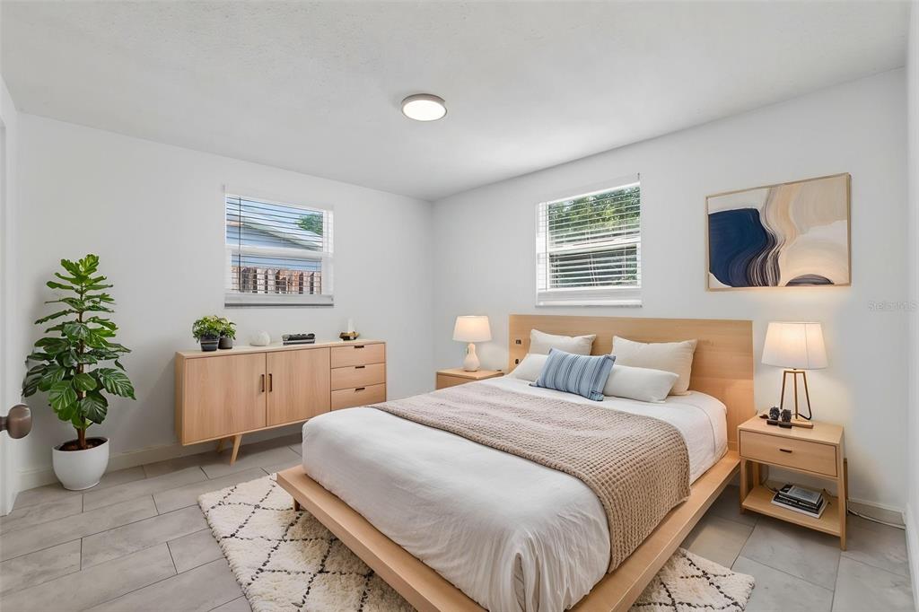 10914 Leeds Road Port Richey, FL 34668 - Photo 10 of 24 a bedroom with a bed and a potted plant