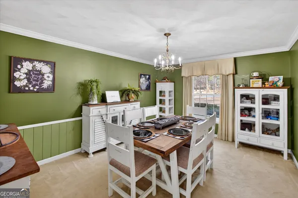 a dining room with furniture and chandelier