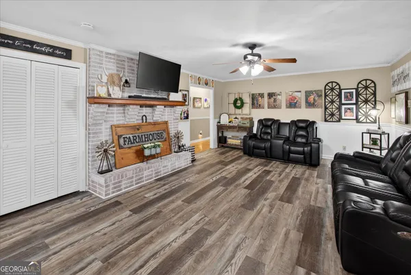 a living room with furniture a flat screen tv and a fireplace