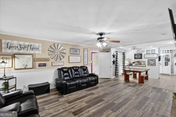 a living room with furniture and a wooden floor