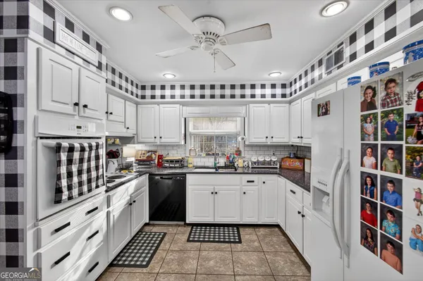 a kitchen with cabinets and window