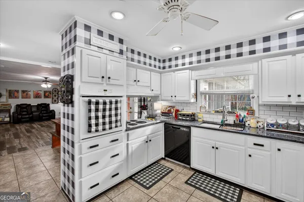 a kitchen with cabinets and window