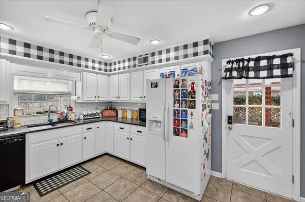 a kitchen with stainless steel appliances and white cabinets