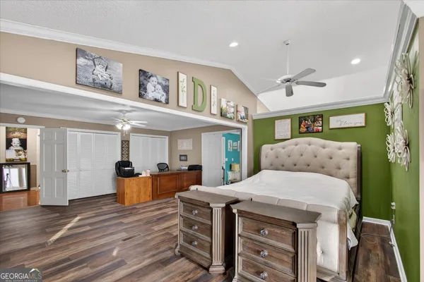 a living room with furniture a dining table and wooden floor
