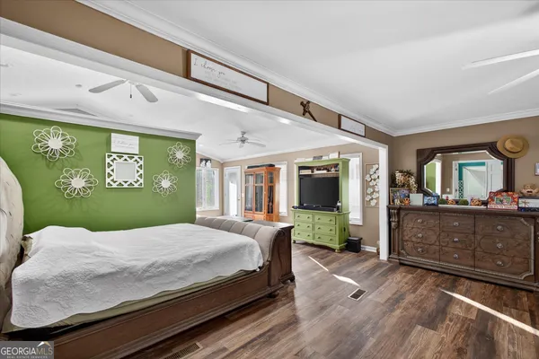 a bed sitting in a spacious bedroom next to a window