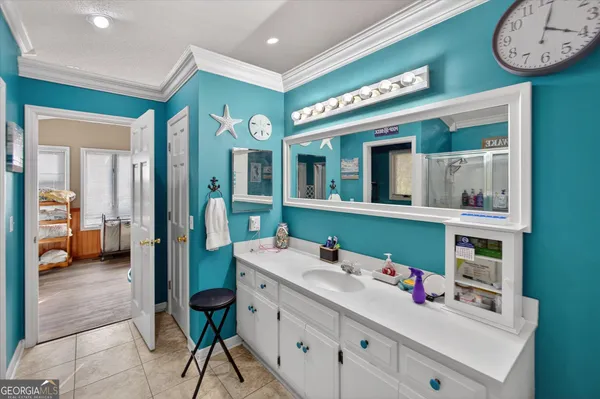 a bathroom with a sink mirror and vanity