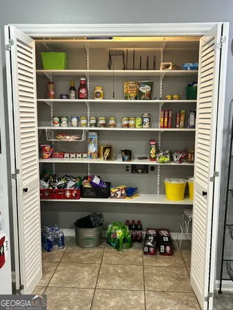 a living room with furniture a dining table and wooden floor