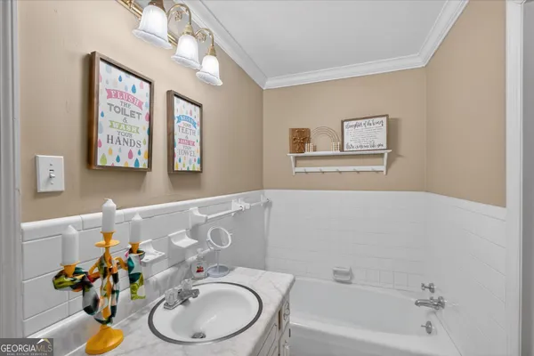 a bathroom with a sink mirror and a bathtub