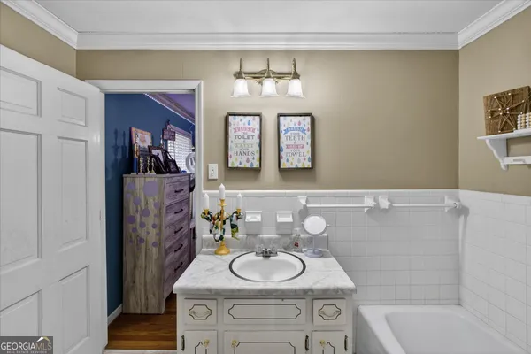 a bathroom with a sink a bathtub and a mirror