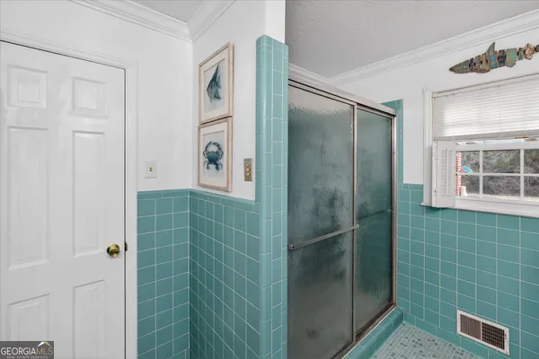 a bathroom with a shower and a sink