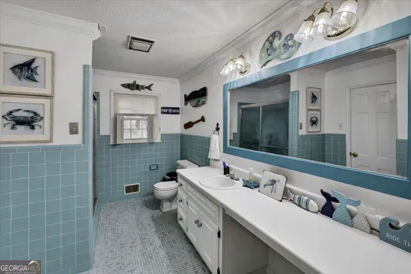 a bathroom with a double vanity sink mirror and bathtub