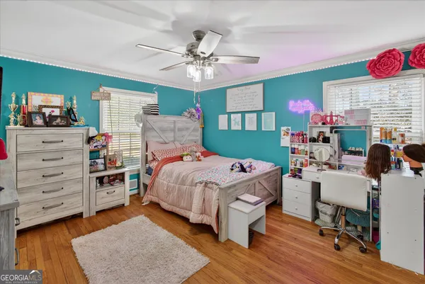 a view of a hallway with wooden floor and workspace
