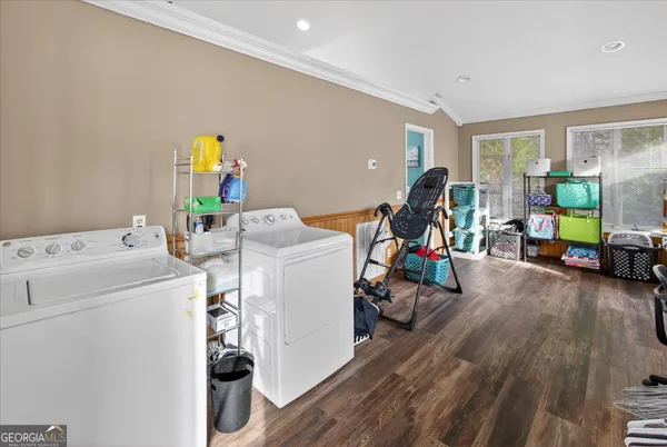a view of a room with wooden floor and iron stairs