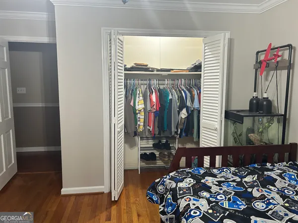 a view of a room with wooden floor and iron stairs